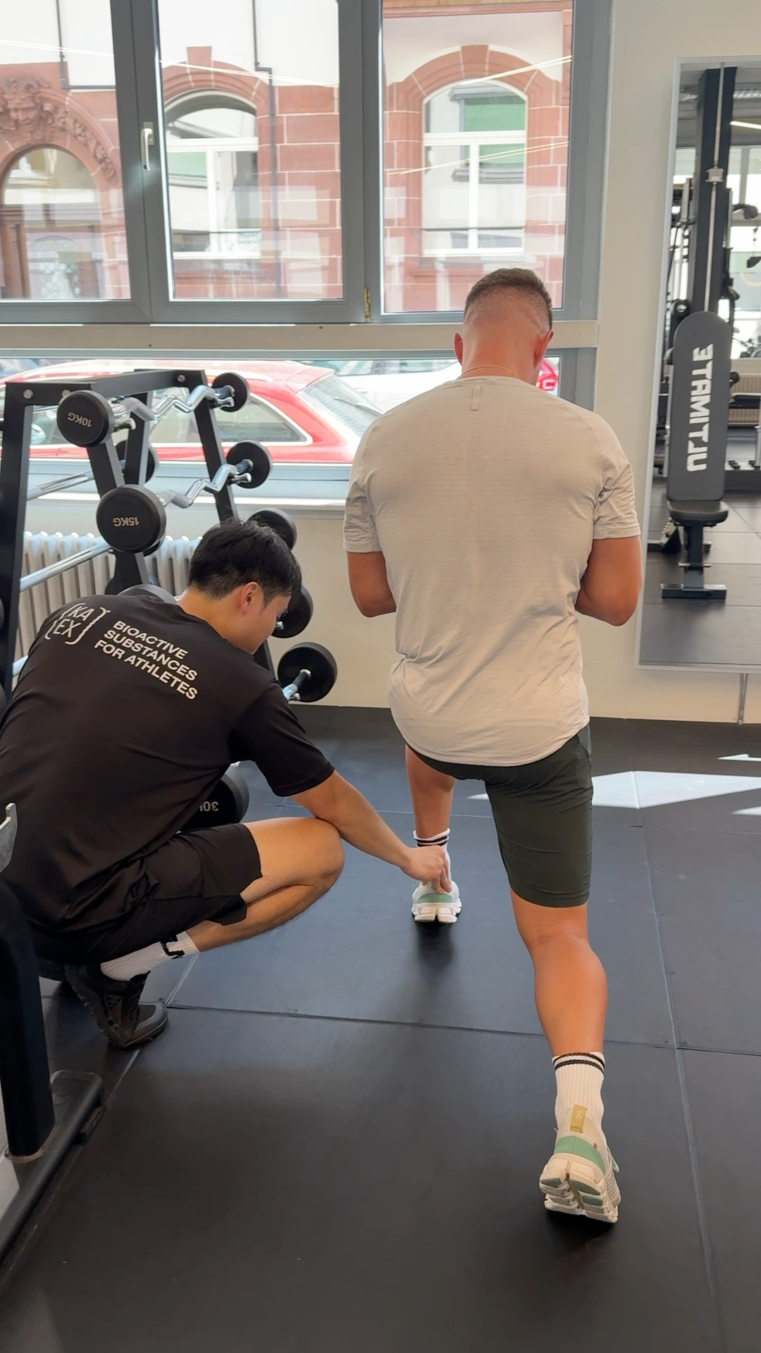 Personal trainer Thanh Nguyen coaching a client in a premium studio